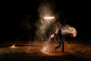 Fire show. Fakir juggles with fire Poi. Night performance. Illusion of a suspended object
