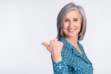 Photo of happy smiling cheerful businesswoman point finger copyspace advertisement isolated on grey...