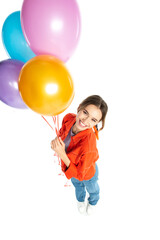 Fototapeta na wymiar high angle view of smiling young woman in orange shirt holding colorful balloons isolated on white