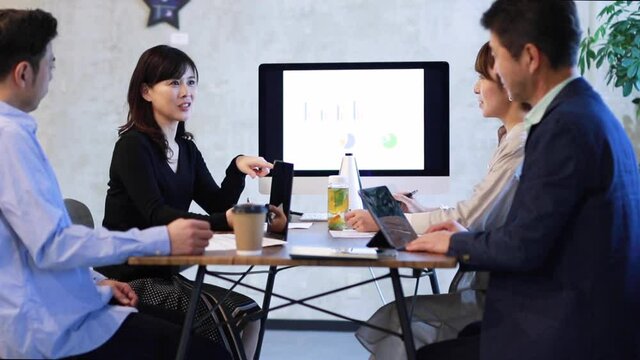 ミーティングをする日本人ビジネスマンとビジネスウーマン