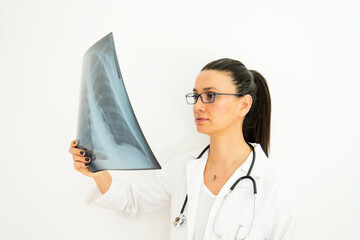 young female doctor with glasses examines x-ray on her hand. selective Focus  x-ray.