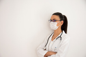young female doctor taking a nap, tired and leaning against the wall. Copy Space. Selective Focus Face.