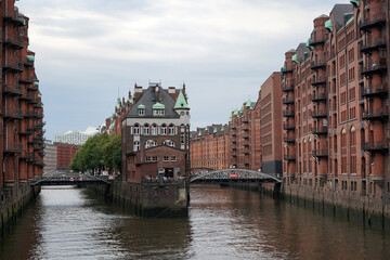 Hamburg Speicherstadt. View from a bridge over the Hamburg warehouse district. In the center there is a restaurant that entertains guests on the terrace