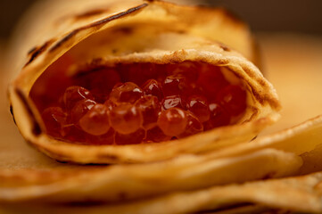 Traditional Russian pancakes with red salmon caviar. Shrovetide week of the meeting of spring.