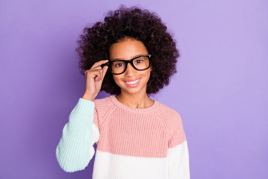 Photo portrait of small schoolgirl wearing glasses geek in knitted sweater isolated violet color background