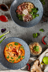 Asian cuisine - Thai Cuisine Tom Yam Soup and Vietnamese Pho Bo Soup. Shrimp Seafood Spicy Soup and Vietnam Beef and Noodle. Authentic cuisine dinner set.