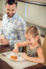 Young father having a breakfast with his daughter