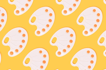 Repetitive pattern made of watercolor palettes on a yellow background. Artistic creative concept.