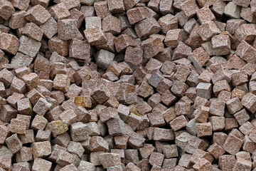 a pile of granite and porphyry paving stones, pattern - obrazy, fototapety, plakaty