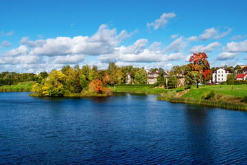 Fototapeta na wymiar Beautiful panoramic autumn landscape with bright trees on the lake shore