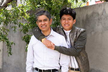 Father and son, hugging each other while smiling