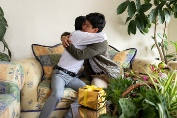 son hugging his dad as he gives him a gift