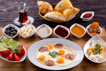 Assorted Middle Eastern and arabic dishes on a dark rustic background. Hummus, tabbouleh, pita, meat kebab, falafel, baklava. Halal food. Top view. Turkish foods, Turkish pizza, Turkish breakfast