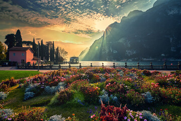 View of the beautiful Lake Garda surrounded by mountains, Scenic view of sunset at Lake Garda in the Riva del Garda with the beautiful sunset colors, italy - obrazy, fototapety, plakaty