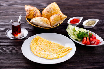 Assorted Middle Eastern and arabic dishes on a dark rustic background. Hummus, tabbouleh, pita, meat kebab, falafel, baklava. Halal food. Top view. Turkish foods, Turkish pizza, Turkish breakfast