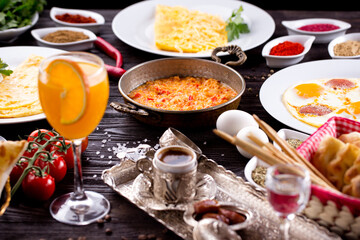 Assorted Middle Eastern and arabic dishes on a dark rustic background. Hummus, tabbouleh, pita, meat kebab, falafel, baklava. Halal food. Top view. Turkish foods, Turkish pizza, Turkish breakfast