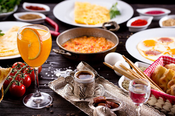 Assorted Middle Eastern and arabic dishes on a dark rustic background. Hummus, tabbouleh, pita, meat kebab, falafel, baklava. Halal food. Top view. Turkish foods, Turkish pizza, Turkish breakfast