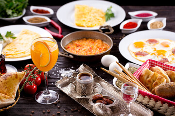 Assorted Middle Eastern and arabic dishes on a dark rustic background. Hummus, tabbouleh, pita, meat kebab, falafel, baklava. Halal food. Top view. Turkish foods, Turkish pizza, Turkish breakfast
