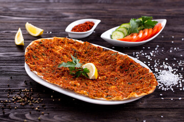 Assorted Middle Eastern and arabic dishes on a dark rustic background. Hummus, tabbouleh, pita, meat kebab, falafel, baklava. Halal food. Top view. Turkish foods, Turkish pizza, Turkish breakfast