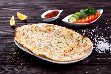 Assorted Middle Eastern and arabic dishes on a dark rustic background. Hummus, tabbouleh, pita, meat kebab, falafel, baklava. Halal food. Top view. Turkish foods, Turkish pizza, Turkish breakfast