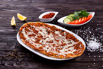 Assorted Middle Eastern and arabic dishes on a dark rustic background. Hummus, tabbouleh, pita, meat kebab, falafel, baklava. Halal food. Top view. Turkish foods, Turkish pizza, Turkish breakfast