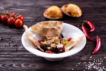 Assorted Middle Eastern and arabic dishes on a dark rustic background. Hummus, tabbouleh, pita, meat kebab, falafel, baklava. Halal food. Top view. Turkish foods, Turkish pizza, Turkish breakfast