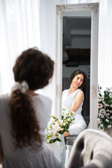 portrait happy smiling girl watching on a side with reflexion in a mirror of herself