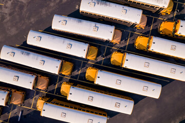 Aerial overhead photo of a parking lot full with school busses - obrazy, fototapety, plakaty