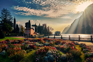 View of the beautiful Lake Garda surrounded by mountains, Scenic view of sunset at Lake Garda in...
