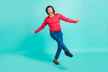 Fototapeta na wymiar Full length photo of charming funky happy young man dance amazed isolated on pastel teal color background