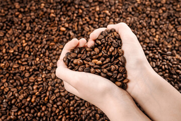 Сoffee beans in hand. View from above