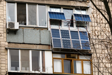 Fototapeta na wymiar The solar battery panels mounted on the balcony of an apartment building in Kyiv, Ukraine. April 2021