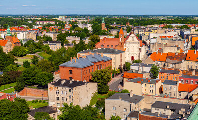 Obraz premium Panoramic aerial view of old town quarter in historic city center with Tumska street, Rynek market square and traditional tenement houses in Gniezno, Poland