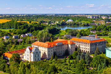 Panoramic aerial view of historic city center with Primate Seminary clerical complex and Jezioro Swietokrzyskie Lake in Gniezno, Poland