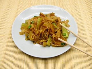 Udon noodles with teriyaki sauce, with vegetables (cucumber, sweet pepper) and sesame seeds