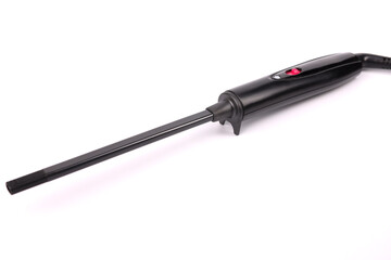 Black hair curling iron lying on white background closeup