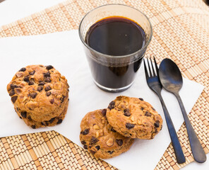 cookies with chocolate and hazelnuts and coffee are on table