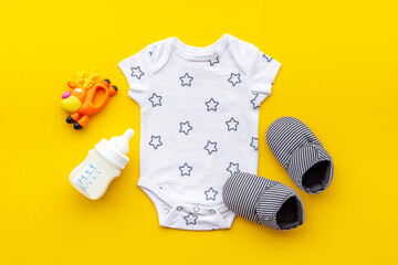 Baby accessories with bodysuit and shoes. Flat lay