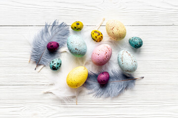 Easter eggs with birds feather. Decoration concept, top view