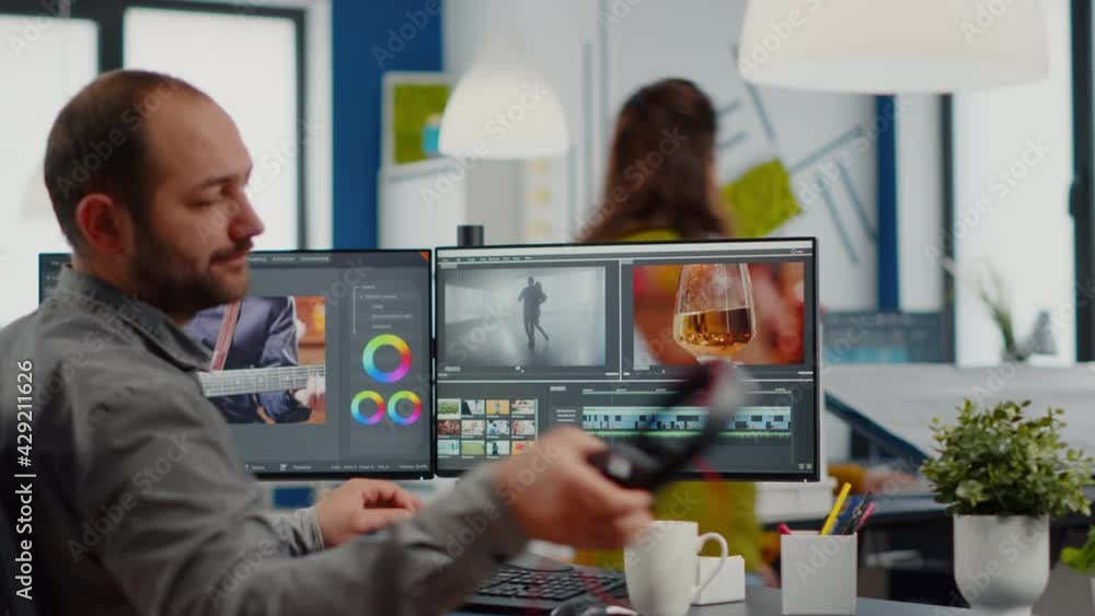 Poster videographer putting on headset editing video project using post production software working in in d