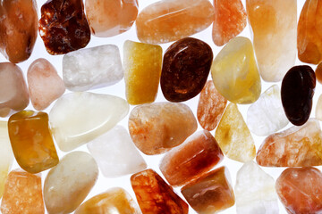 Red silk jade heap jewel stones texture on white light isolated background. Place for text.