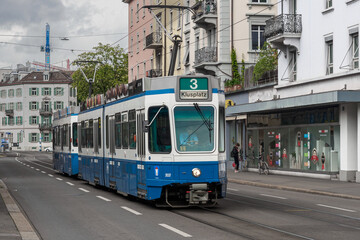 Fototapeta na wymiar Switzerland, Zurich - November, 2020 - Typical blue tram on the streets of Zurich