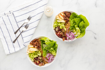 Top down view of two Waldorf salad bowls ready for eating.