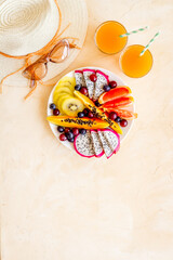 Tropical fruits breakfast plate. Vacation and diet meal. View from above