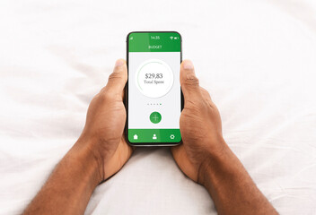 Black man using financial app on mobile phone