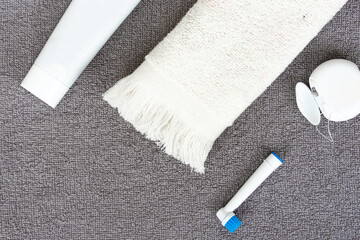 Toothpaste, toothbrush, dental floss on a gray background. Dental hygiene.