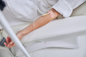 Woman hand on medical armchair on the medicine armchair with syringe vitamin in beauty center