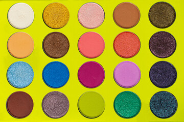 Various luxury makeup products on dark background, flat styling.