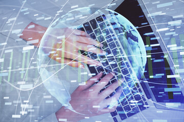 Double exposure of woman hands working on computer and financial theme hologram drawing. Top View. Business concept.