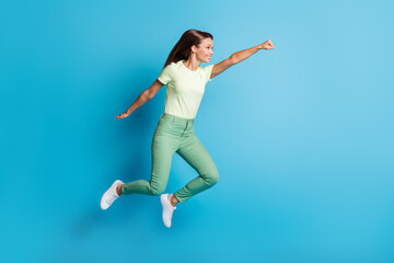 Fototapeta na wymiar Full length body size photo of pretty girl flying super woman in casual outfit isolated on bright blue color background